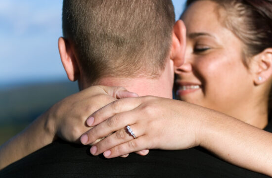 a young happy couple that just got engaged shallow depth of field with focus on the diamond engagement ring SKtgXj RBj