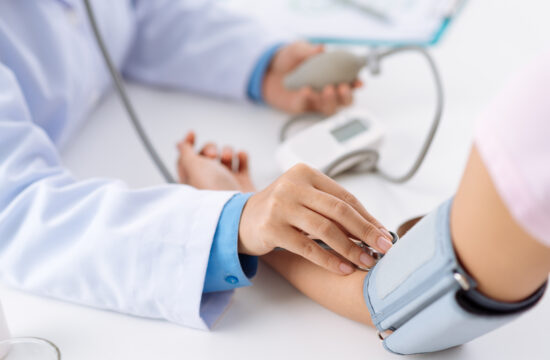 storyblocks doctor taking pulse of the patient who has life insurance policy view from the top rUTTENpbf