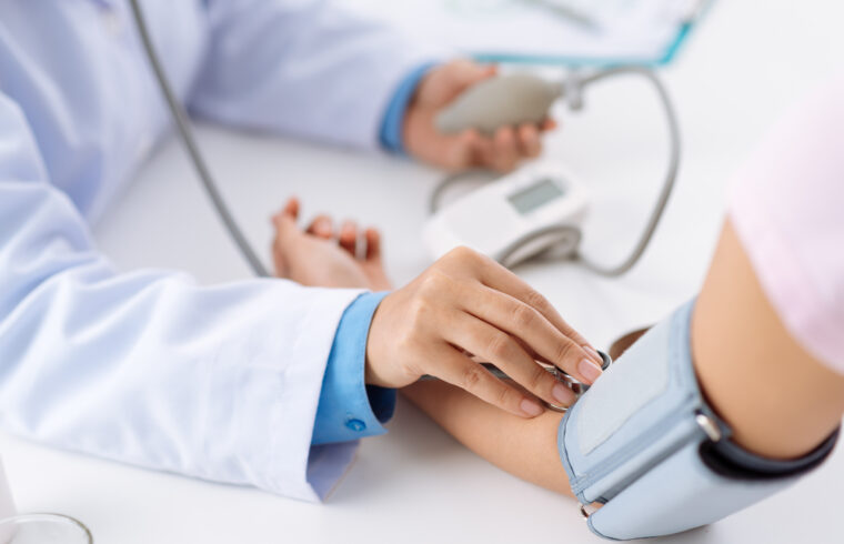 storyblocks doctor taking pulse of the patient who has life insurance policy view from the top rUTTENpbf