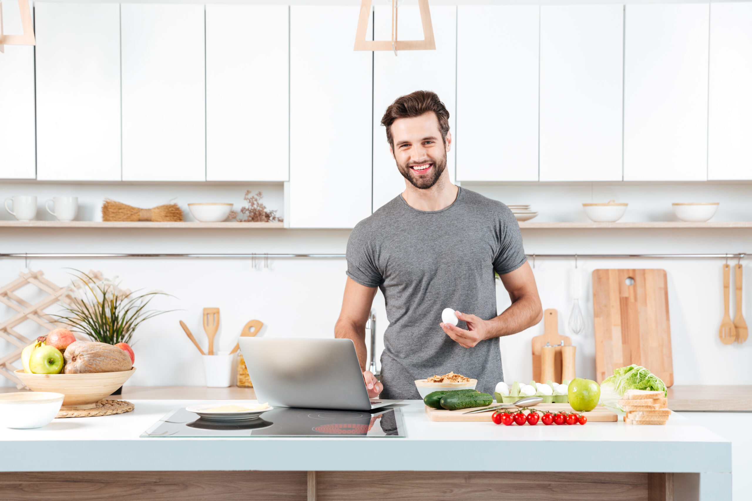 Eating Healthy on a Budget: Affordable Meal Plans for Weight Loss 4 storyblocks attractive young man cooking with mixing bowl and looking at camera in the kitchen H0bCFaja9W scaled