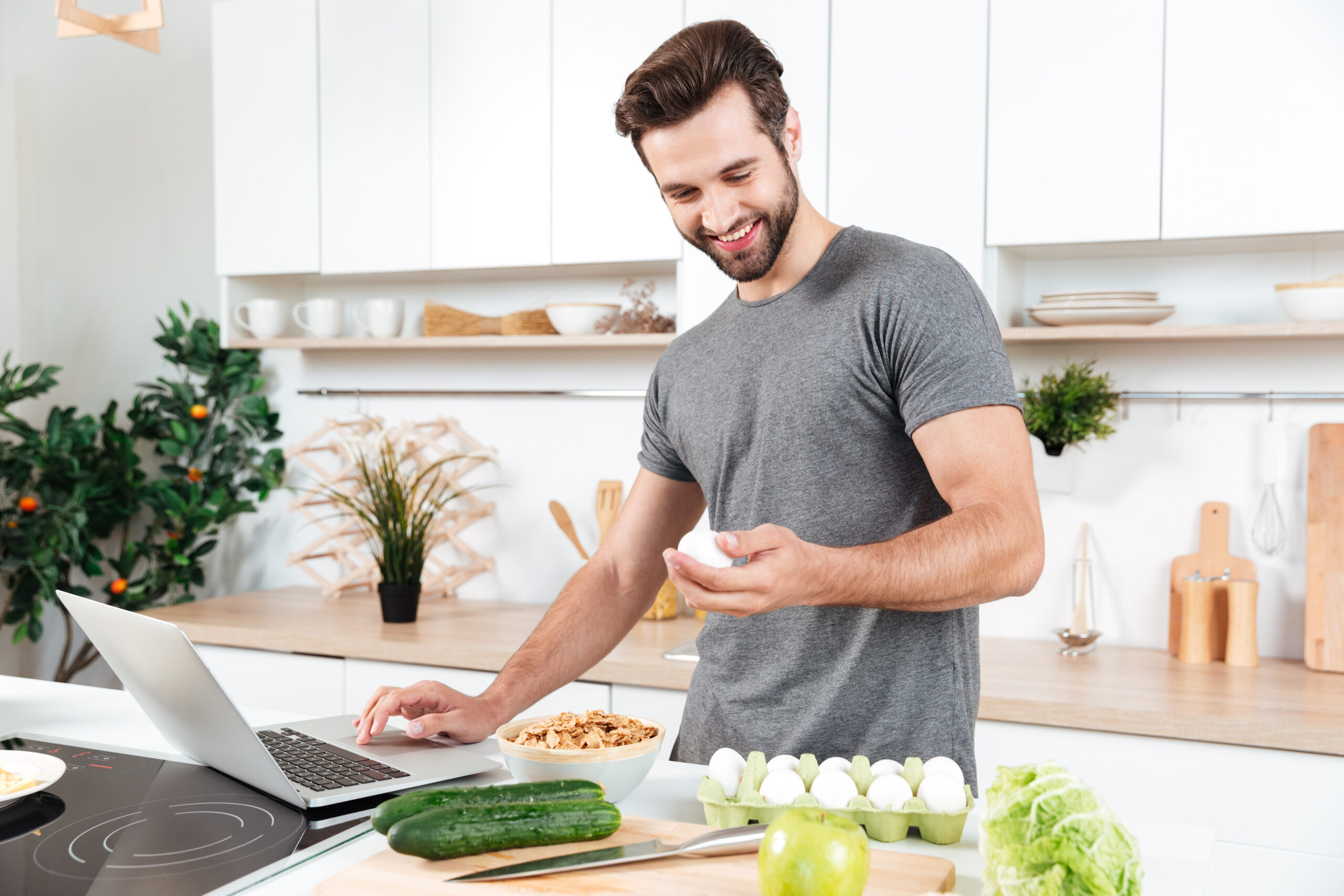 The Best Diet for Your Body Type: Discover What Works for You 4 storyblocks man with laptop preparing food at the kitchen at home SAeAt6s6qb scaled