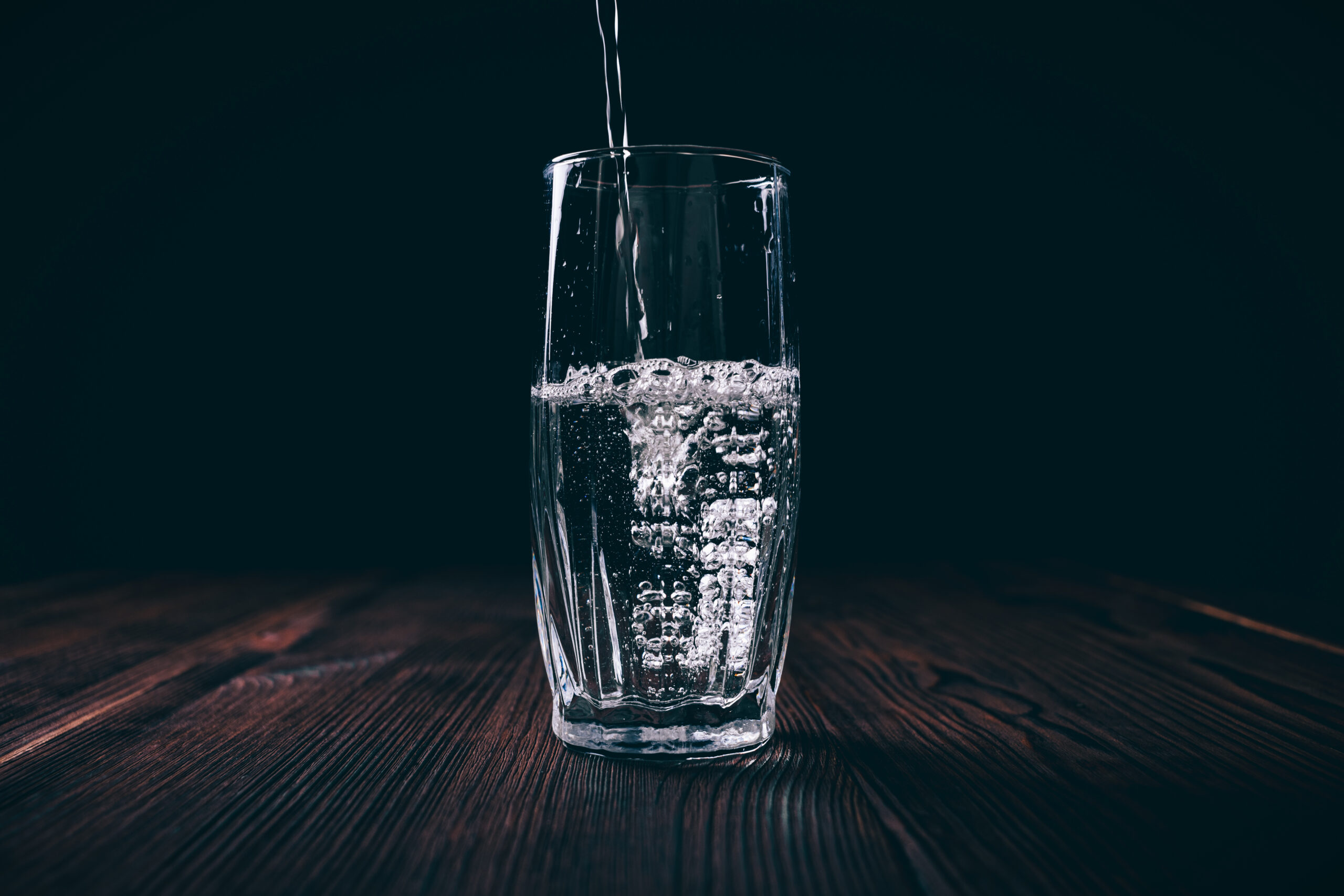 Getting Real About Weight Loss: Why Slow and Steady Wins the Race (and How to Make It Happen 3 graphicstock water poured into a faceted glass on a black background dark contrast lighting BbPD8Hh2vW scaled