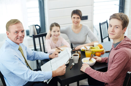 storyblocks high angle view of lovely family posing for photography while eating healthy breakfast at home waist up portrait S8e8UrwAb