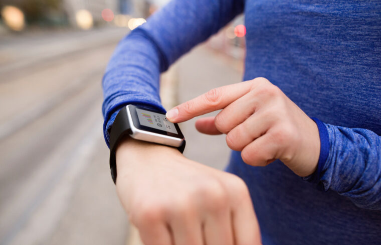 graphicstock hands of unrecognizable young woman running in the city using a fitness app on her smartwatch for tracking weight loss progress running goal or summary of her run rear view BdHqD2HzZ
