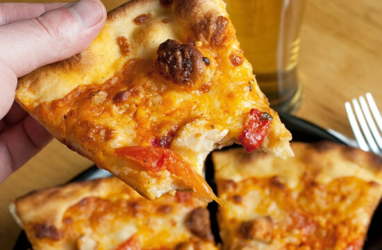 a male hand feeding himself buffalo chicken pizza from the first person point of view shallow depth of field SY0fLc0Si