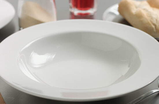 storyblocks delicious freshly made hot steaming chicken and lentil soup in a white wide rimmed plate H8Egvv40Z 1