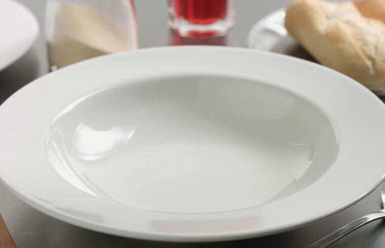 storyblocks delicious freshly made hot steaming chicken and lentil soup in a white wide rimmed plate H8Egvv40Z 1
