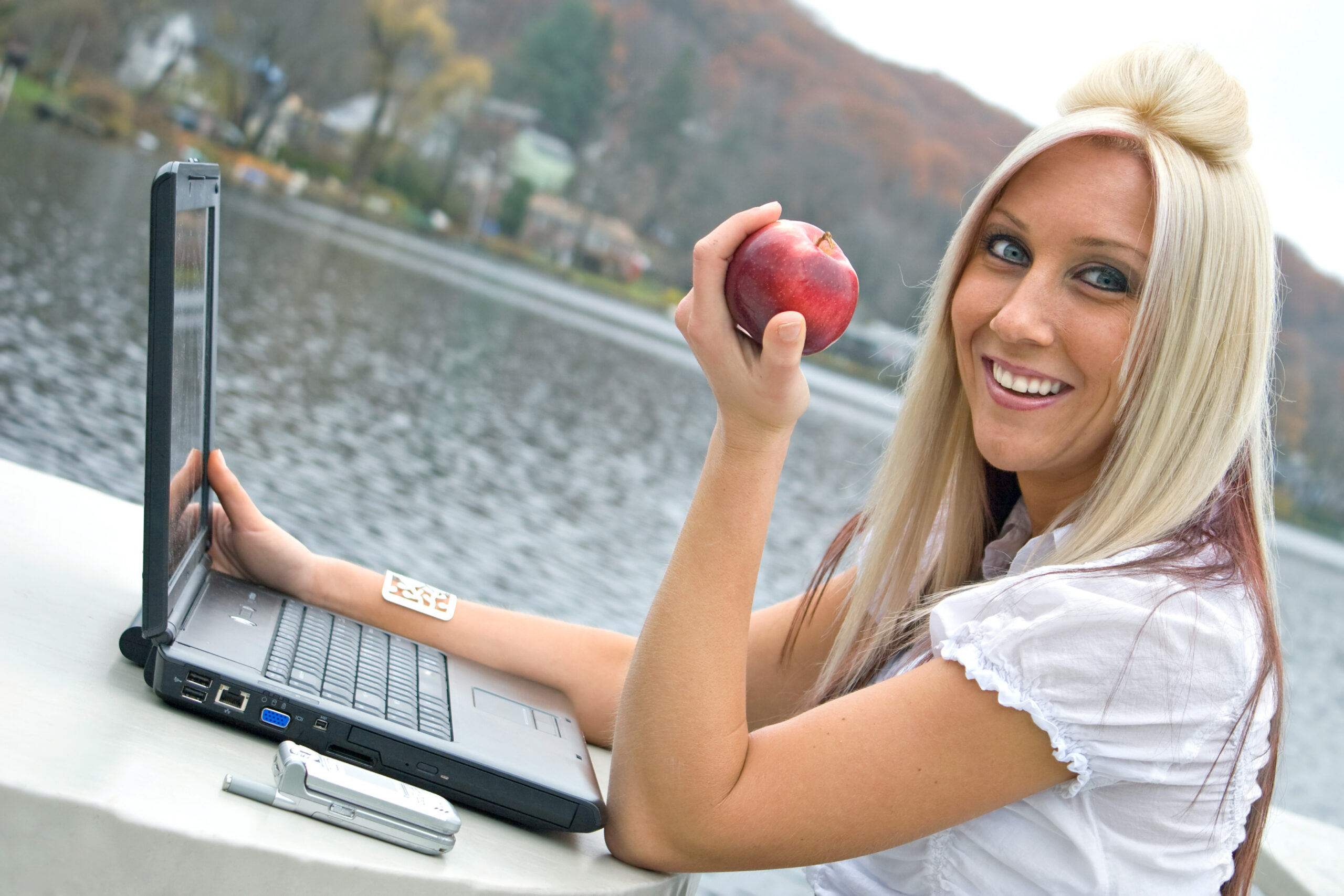 Discover the Best Foods to Eat for a Flatter Tummy and Better Digestion 3 a beautiful young blonde woman in a mobile business setting eating a red apple while using her laptop notebook computer SKhcJdRBo scaled