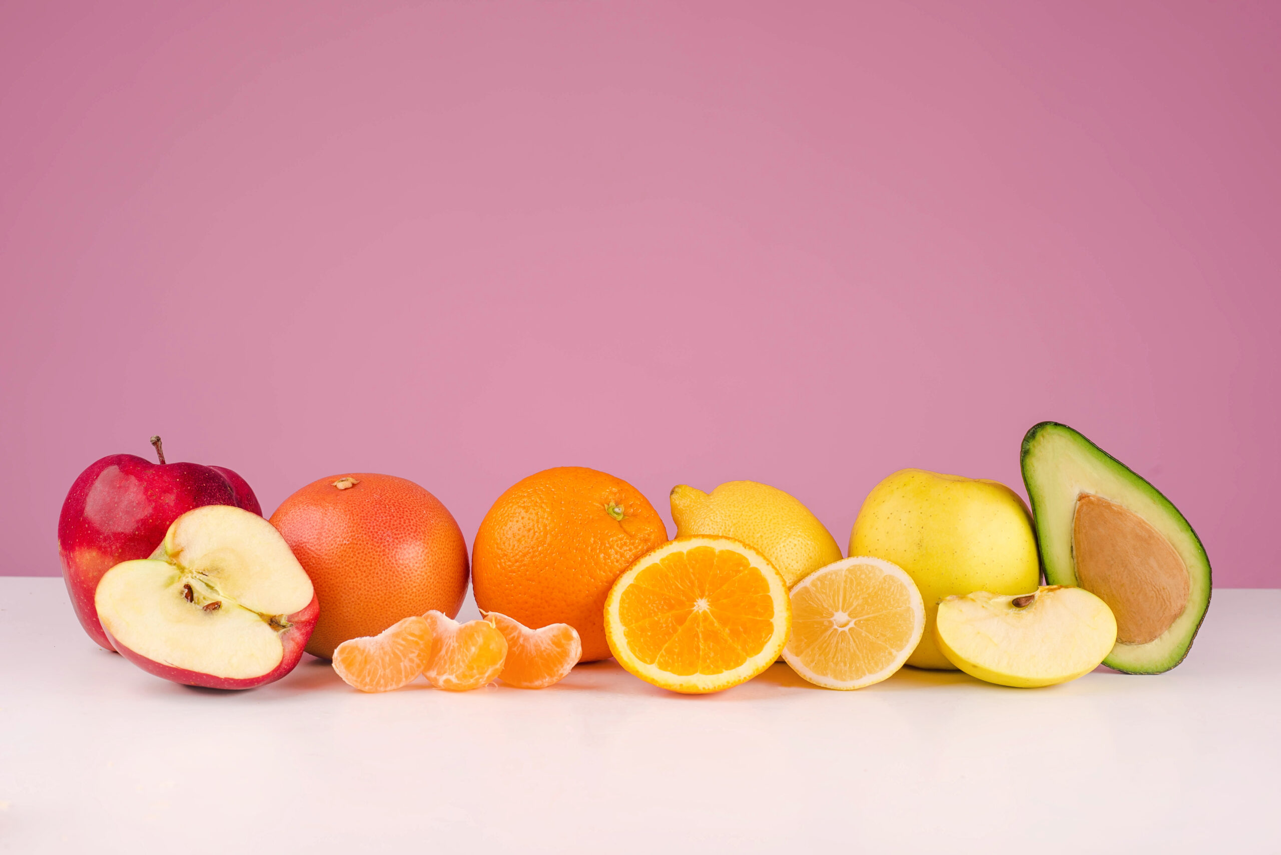 How to Stick to Your Diet and See Results Fast 5 graphicstock composition with fresh sliced peeed fruits apple grapefruit orange lemon apple avocado on a table isolated on a pink background r8vlJYuXunx scaled