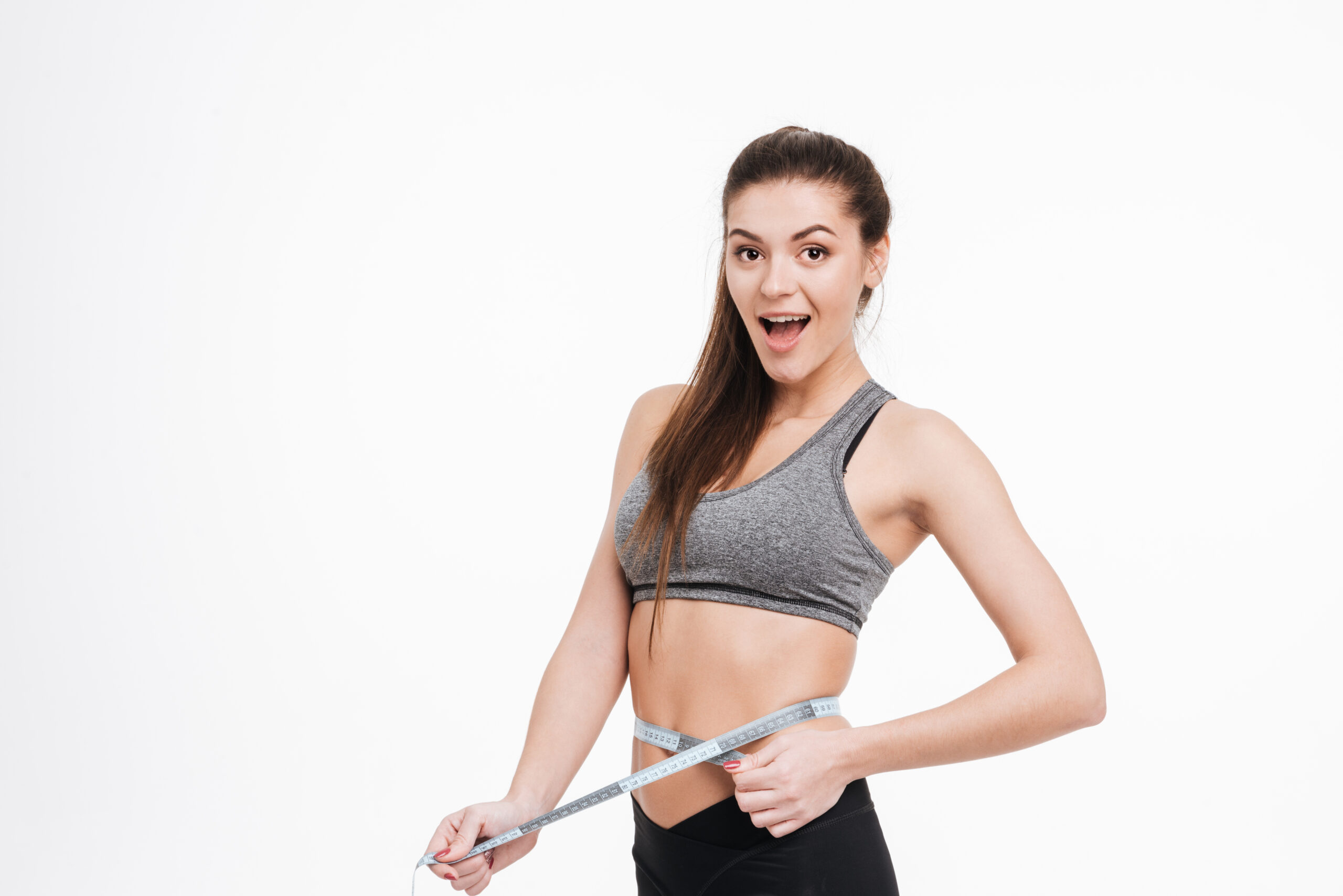 Debunking the Myths of Fad Diets: What Really Works for Long-Term Weight Loss 4 graphicstock portrait of a happy surprised sports woman holding tape measure around her waist isolated on a white background rLkeZ1YQOhx scaled