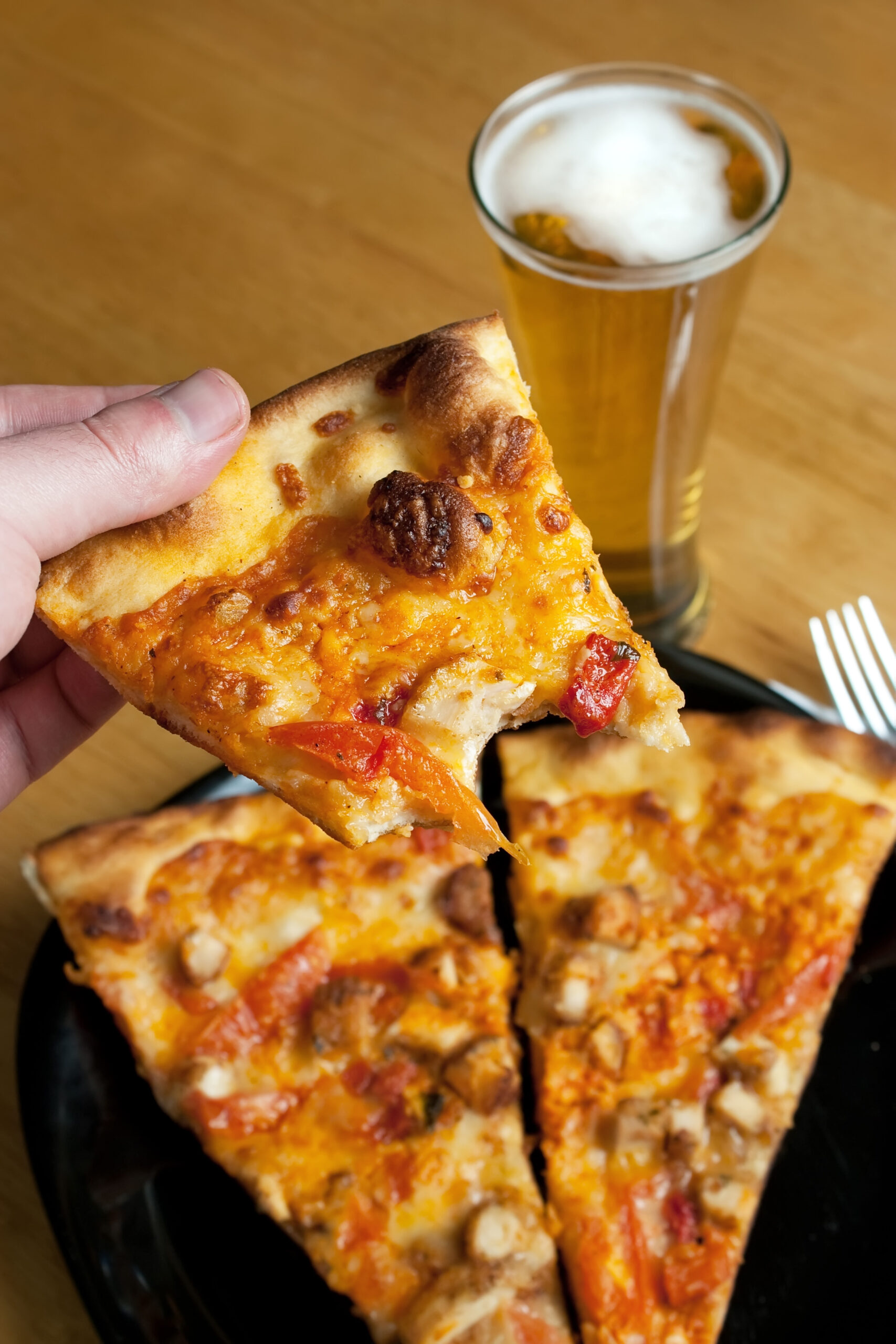 Dieting Myths Debunked: Separating Fact from Fiction in the World of Nutrition 3 a male hand feeding himself buffalo chicken pizza from the first person point of view shallow depth of field SY0fLc0Si scaled
