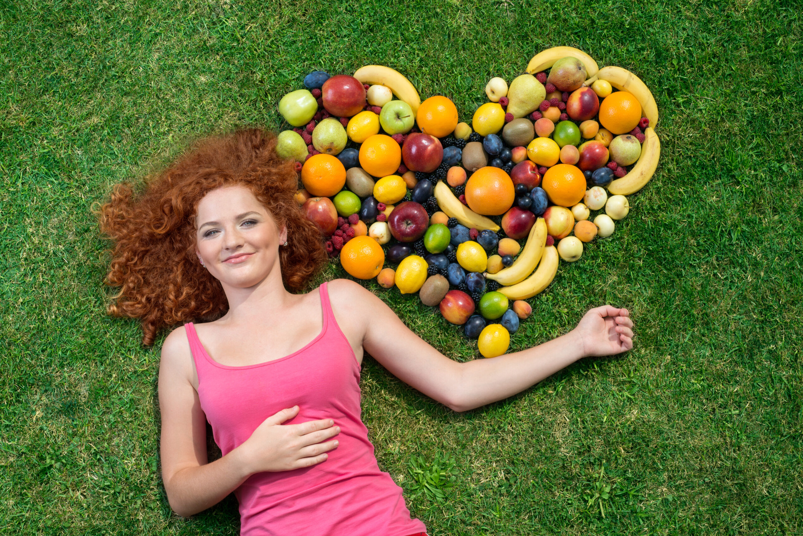 graphicstock girl with fruit lying on the grass BAn3i5qWW scaled